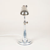 A small chrome articulated desk lamp with a rounded trough shade. French, early 20th century.
