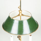 A 19th century brass bouillotte lamp with green painted tole shade.