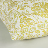 A 18” square cushion made up in a pale green patterned fabric.