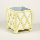 Trellis planter - A square painted wooden planter with trellis details to the sides and mounted on ball feet, with a metal liner.