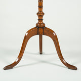 A small round table with a painted faux marquetry top and a turned central support on a tripod base. Early 19th century.