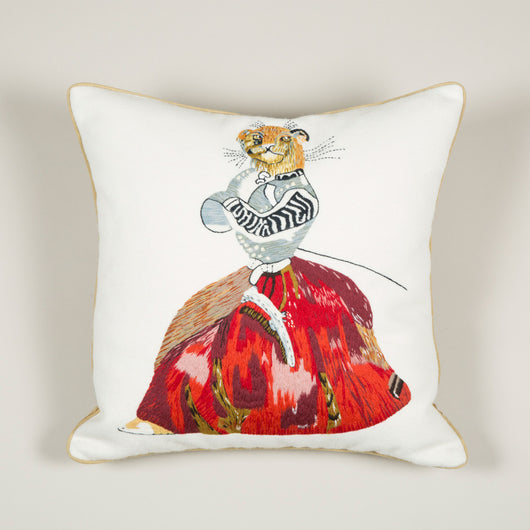 A needlepoint cushion of a lioness in a dress inspired by Nancy Lancaster's tablecloth at Ditchley depicting animals from J.J. Grandville fable 'Scenes de la vie privees et publiques des animaux'.