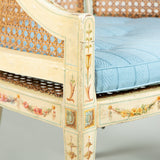 A late 18th century painted beech tub chair with caned back, arms and seat. Neoclassical decoration later.