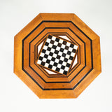 A small octagonal Syrian table with an inset chess board top and Moorish arches enclosing a lower tier.