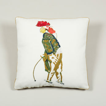 A needlepoint cushion of a cockerel in breeches inspired by Nancy Lancaster's tablecloth at Ditchley depicting animals from J.J. Grandville fable 'Scenes de la vie privees et publiques des animaux'.