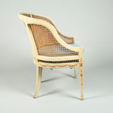A late 18th century painted beech tub chair with caned back, arms and seat. Neoclassical decoration later.