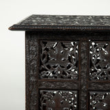 A low rectangular Kashmiri hardwood table with densely-carved foliate decoration and folding base.
