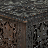 A low rectangular Kashmiri hardwood table with densely-carved foliate decoration and folding base.