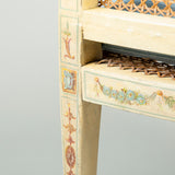 A late 18th century painted beech tub chair with caned back, arms and seat. Neoclassical decoration later.