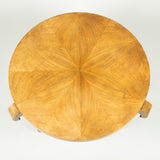 A low round sycamore table, the segmentally veneered top on three scroll supports joined by a lower tier. 20th century. French circa 1940.