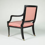 A George III black painted library armchair with curved square back and spiral-twisted front legs. Circa 1800.