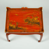 A red and gilt chinoiserie decorated tray on a stand, early 20th century European.