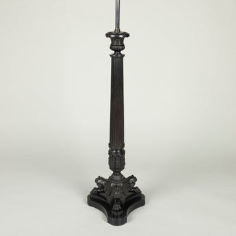 A pair of tall bronze column lamps with campagna capitals and claw tripod feet. Not antique.