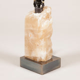 A block of rock crystal mounted on a brass base, wired as a lamp; modern, £950.00 + vat.