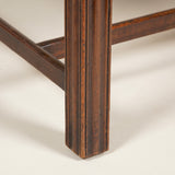 A high-backed Chippendale period wing arm-chair with mahogany moulded legs and cross-stretcher. English, circa 1770.
