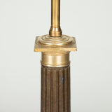 A black tole and brass lamp base in the form of a fluted Doric column. French late 19th century, early 20th century.