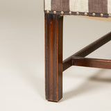 A high-backed Chippendale period wing arm-chair with mahogany moulded legs and cross-stretcher. English, circa 1770.