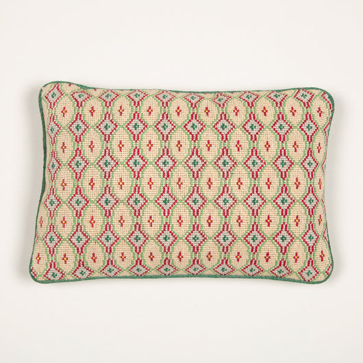 A cushion made up from an archive Colefax green and red boucle backed with green strie.