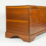 An outsize country house cedarwood blanket chest on a plinth base with shaped bracket feet 18th/early 19th C.
