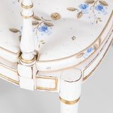 An elegant ivory-lacquered and gilt Sheraton style open armchair with caned seat. Probably 2nd half of the 19th century.