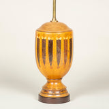 A turned wood urn decorated with geometric marquetry, early 20th century, wired as a lamp.