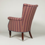 A George IV library armchair with a high back and carved mahogany lyre front. Circa 1830.