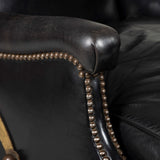 A small black leather covered club armchair with a square adjustable back. French, possibly Maison Jansen, circa 1950.