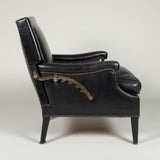 A small black leather covered club armchair with a square adjustable back. French, possibly Maison Jansen, circa 1950.