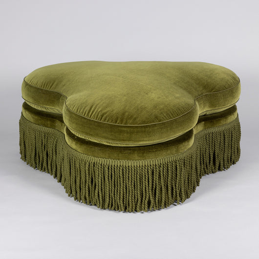 A late 19th or early 20th century trefoil ottoman, re-upholstered in green velvet.
