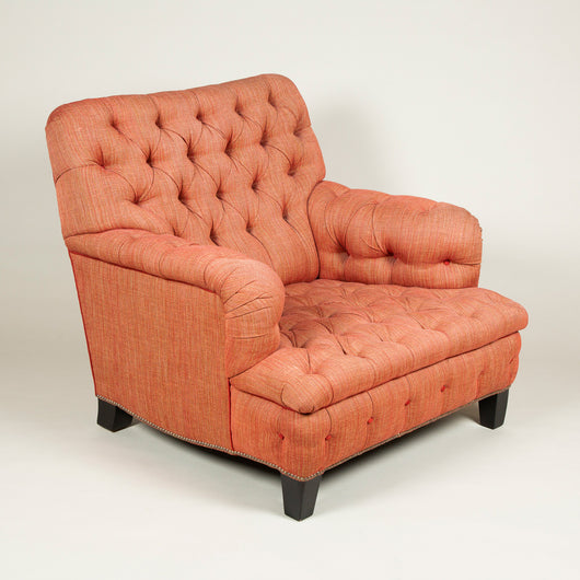 An unusually wide easy armchair with a square back and deep-buttoned upholstery. 20th century.