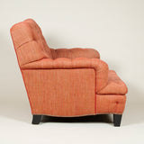 An unusually wide easy armchair with a square back and deep-buttoned upholstery. 20th century.