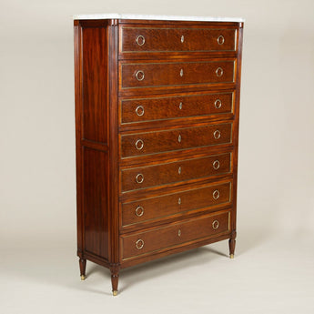 A French Directoire style fine quality mahogany seven-drawer semainier with brass mounts and ring handles, fluted columns at the corners front and back and plum pudding figuring to the drawer panels. Probably early 19th C.