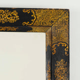 A rectangular 19th century mirror with black and gilt wedge-shaped frame.    IT