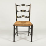 A George III painted side chair with arched ladder back and rush seat. Circa 1780,  original decoration.