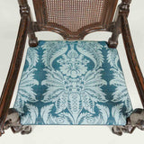 A late 17th century high-back armchair with caned back panel and seat. Traces of original painted finish.