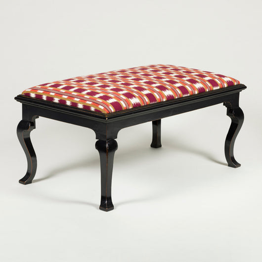 A rectangular stool with padded seat and ebonised 19th century rectangular base with cabriole legs.
