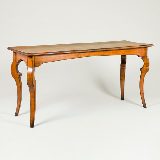 A stylish fruitwood rectangular table with unusual cabriole legs. French, 19th century or early 20th century.