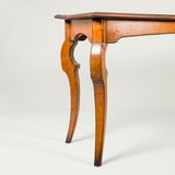 A stylish fruitwood rectangular table with unusual cabriole legs. French, 19th century or early 20th century.