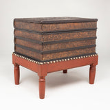 A low table in the form of a pile of leather covered books on a stand. 19th century French.