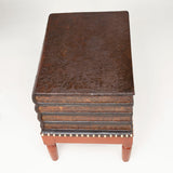 A low table in the form of a pile of leather covered books on a stand. 19th century French.