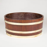 An oval brass-bound coopered mahogany wine cooler or planter. Probably late 19th or early 20th century.