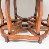 An unusual round chestnut wood table with six cabriole legs and a two-tier open base. Chinese, 19th century.