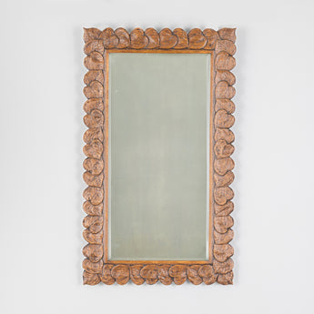 A rectangular mirror with oak frame, carved with overlapping leaves and bevelled plate. Early 20th century from a White Star line ship.